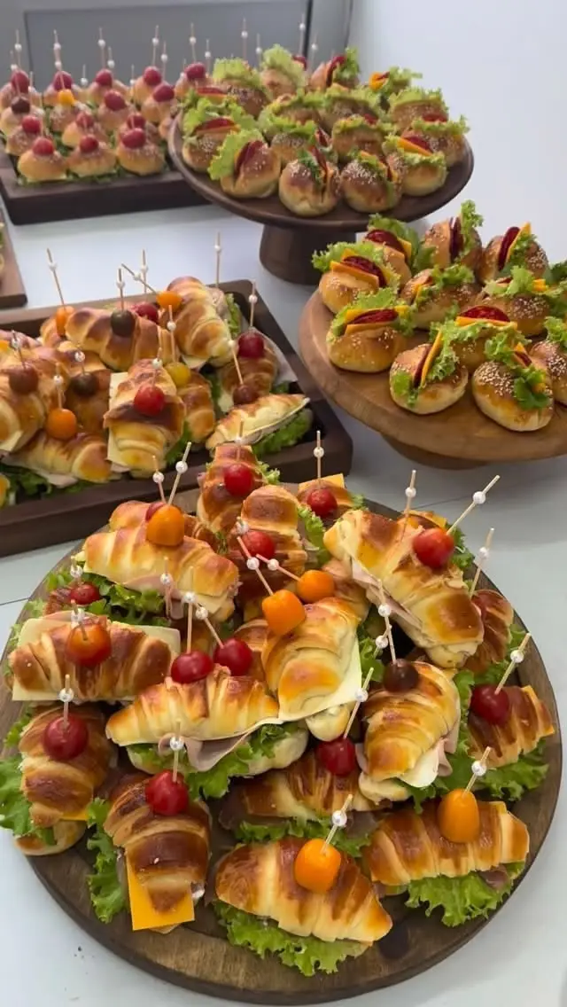 Platouri cu croissante si mini sandvisuri, pe tocatoare de lemn